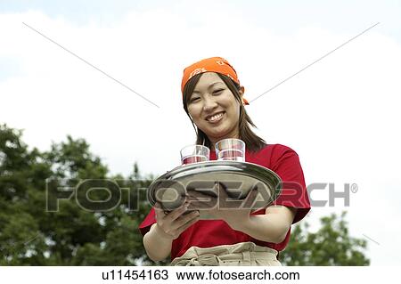 Waitress carrying drinks on tray View Large Photo Image Stock Image - Waitress carrying drinks on tray. Fotosearch