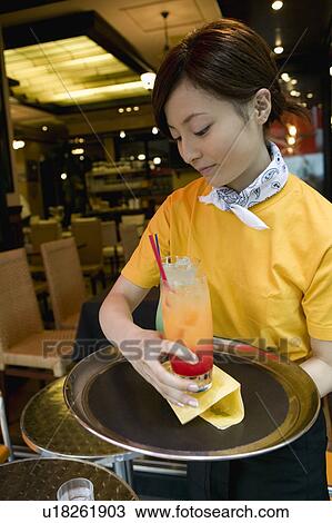 Waitress carrying drinks on tray View Large Photo Image Stock Image - Waitress carrying drinks on tray. Fotosearch