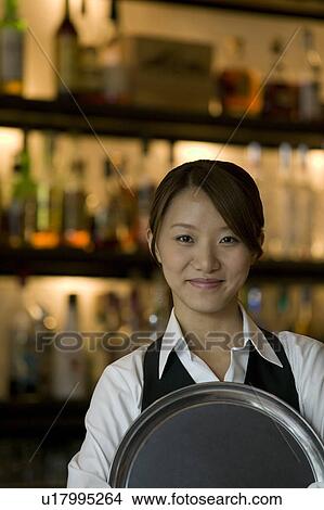 Picture - Waitress holding tray. Fotosearch