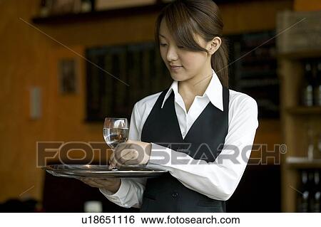 Waitress holding tray with glasses of water View Large Photo Image Stock Photograph - Waitress holding tray with glasses of water. Fotosearch