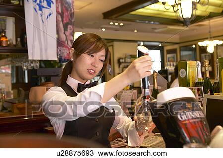 Waitress pouring beer from tap View Large Photo Image Stock Image - Waitress pouring beer from tap. Fotosearch