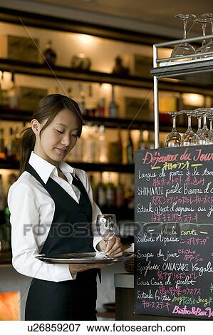 Waitress putting glass on tray View Large Photo Image Stock Photo - Waitress putting glass on tray. Fotosearch