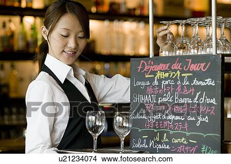 Waitress putting glasses on tray View Large Photo Image Picture - Waitress putting glasses on tray. Fotosearch