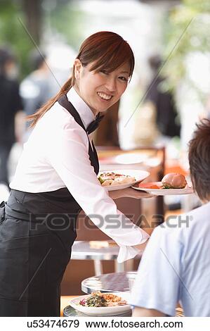 Waitress serving food View Large Photo Image Stock Photo - Waitress serving food. Fotosearch