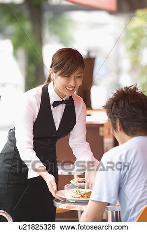 Stock Photograph - Waitress serving food. Fotosearch