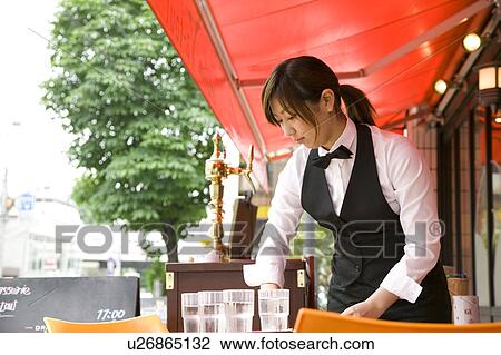 Waitress setting table View Large Photo Image Stock Image - Waitress setting table. Fotosearch