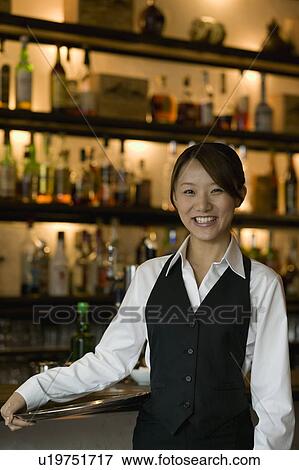 Waitress standing in front of bar counter View Large Photo Image Stock Photo - Waitress standing in front of bar counter. Fotosearch