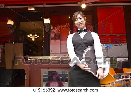 Waitress standing in front of coffee shop View Large Photo Image Stock Image - Waitress standing in front of coffee shop. Fotosearch