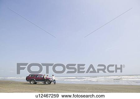 Car parked on beach View Large Photo Image Stock Photo - Car parked on beach. Fotosearch