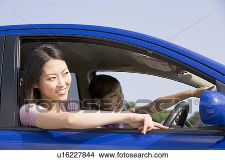 Two young women in car View Large Photo Image Picture - Two young women in car. Fotosearch