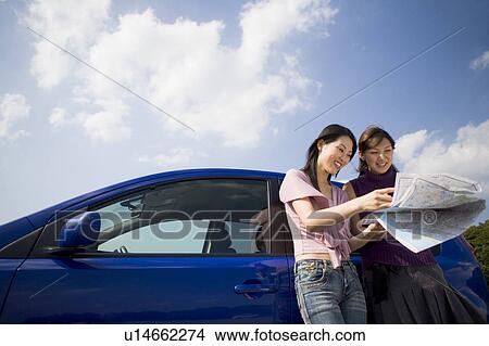 Two young women looking at map View Large Photo Image Picture - Two young women looking at map. Fotosearch