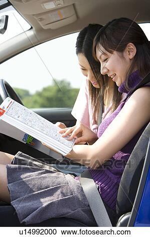 Two young women looking at map View Large Photo Image Stock Image - Two young women looking at map. Fotosearch