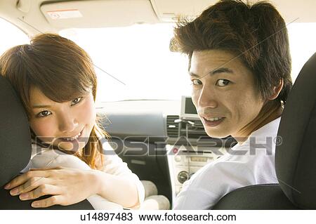 Stock Image - Young couple in car. Fotosearch
