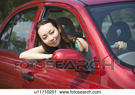 Young woman driving car View Large Photo Image Stock Image - Young woman driving car. Fotosearch