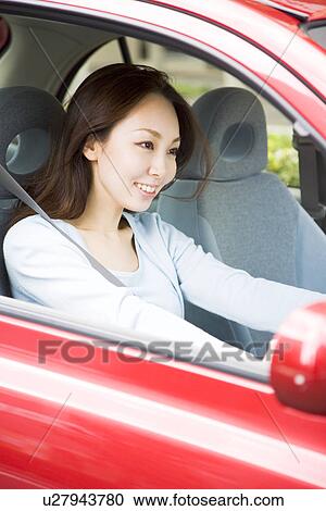 Young woman driving car View Large Photo Image Stock Image - Young woman driving car. Fotosearch