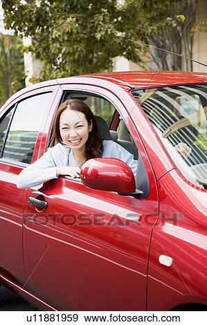 Young woman driving car View Large Photo Image Stock Photo - Young woman driving car. Fotosearch