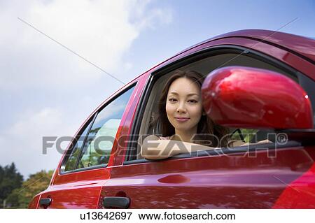 Young woman driving car View Large Photo Image Stock Photo - Young woman driving car. Fotosearch