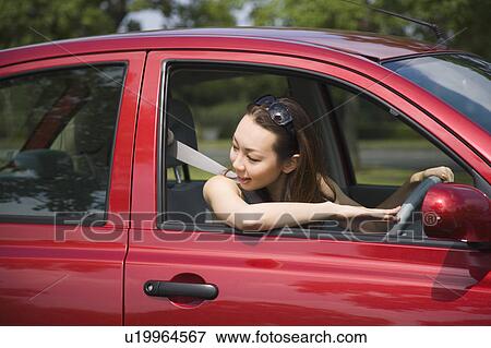 Stock Photo - Young woman driving car. Fotosearch