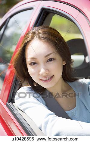 Young woman driving car View Large Photo Image Stock Photograph - Young woman driving car. Fotosearch