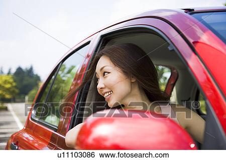 Young woman driving car View Large Photo Image Stock Photograph - Young woman driving car. Fotosearch