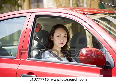 Stock Photography - Young woman driving car. Fotosearch