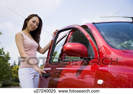 Young woman opening car door View Large Photo Image Stock Photography - Young woman opening car door. Fotosearch