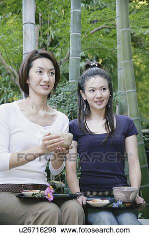 Stock Photo - Two young women drinking green tea. Fotosearch