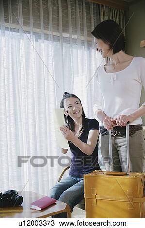 Stock Image - Two young women in Japanese style inn. Fotosearch