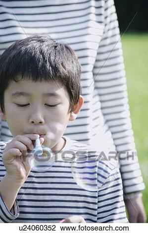 Boy blowing bubbles View Large Photo Image Stock Image - Boy blowing bubbles. Fotosearch