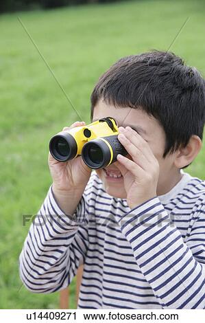 Stock Image - Boy using binoculars. Fotosearch