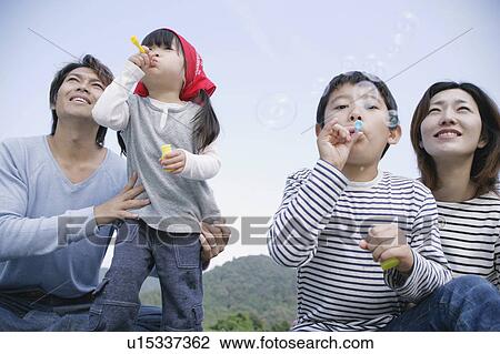 Family blowing bubbles View Large Photo Image Stock Image - Family blowing bubbles. Fotosearch