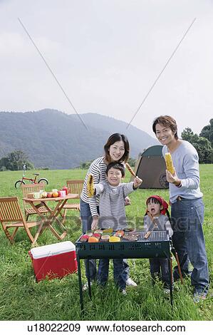 Stock Photo - Family enjoying picnic. Fotosearch