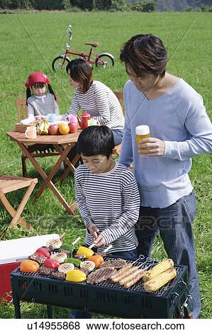 Family having barbeque View Large Photo Image Stock Photo - Family having barbeque. Fotosearch