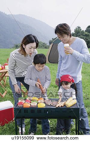 Family having barbeque View Large Photo Image Stock Photo - Family having barbeque. Fotosearch