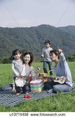 Stock Photo - Family having picnic. Fotosearch