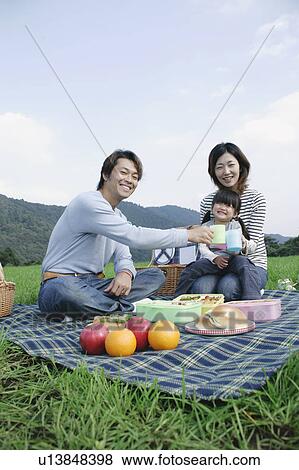 Stock Photo - Family having picnic. Fotosearch