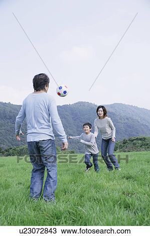 Family playing soccer in meadow View Large Photo Image Stock Image - Family playing soccer in meadow. Fotosearch