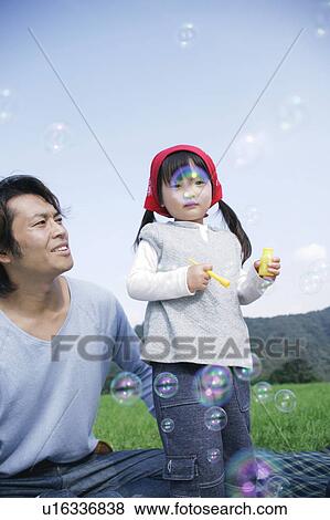 Father and daughter blowing bubbles View Large Photo Image Stock Photo - Father and daughter blowing bubbles. Fotosearch