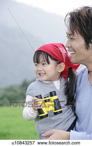 Stock Photo - Father and daughter using binoculars. Fotosearch