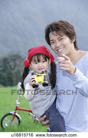 Stock Photograph - Father and daughter using binoculars. Fotosearch