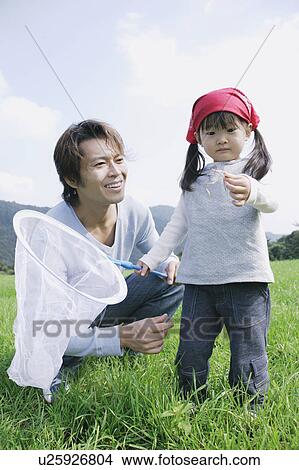 Picture - Father and daughter with butterfly net. Fotosearch