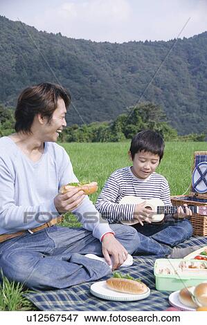 Stock Photo - Father and son having picnic. Fotosearch