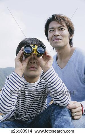 Father and son using binoculars View Large Photo Image Picture - Father and son using binoculars. Fotosearch