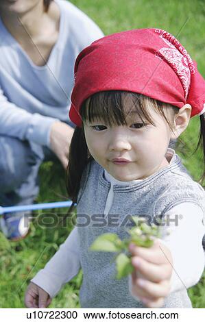 Girl holding leaves View Large Photo Image Stock Image - Girl holding leaves. Fotosearch