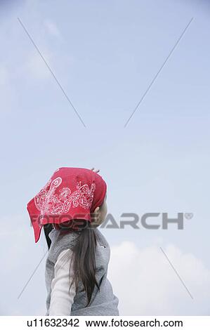 Stock Image - Girl looking at sky. Fotosearch