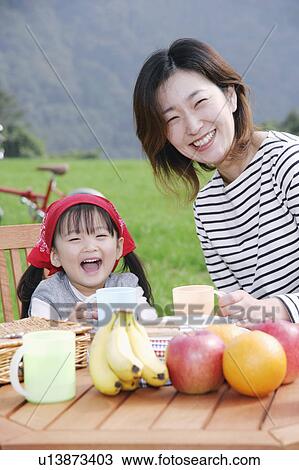 Mother and daughter sitting at picnic table View Large Photo Image Stock Image - Mother and daughter sitting at picnic table. Fotosearch