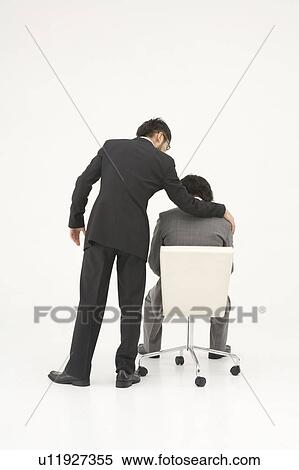 Stock Photography - Businessman consoling his colleague. Fotosearch