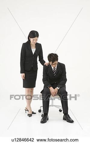 Stock Image - Businesswoman consoling her colleague. Fotosearch