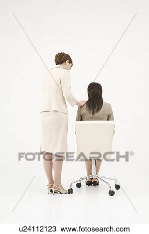 Stock Image - Businesswoman consoling her colleague. Fotosearch