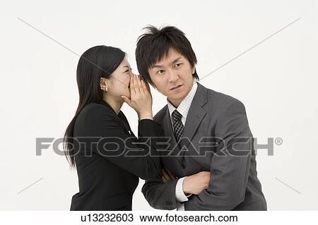 Businesswoman whispering to businessman View Large Photo Image Stock Image - Businesswoman whispering to businessman. Fotosearch